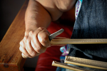Craftsman hands sewing working with vegetable fiber