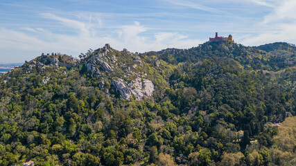Aerial view of Pena National Palace and Castelo dos Mouros, Sintra, Portugal, on top of the mountain
