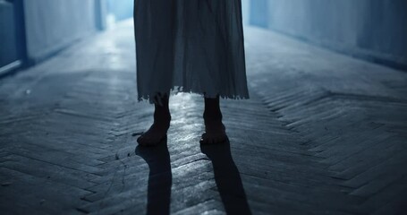 Little caucasian girl in ghost white sundress costume for halloween roaring into camera, frightening someone in hallway of haunted house 4k footage