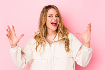 Young caucasian woman isolated on pink background receiving a pleasant surprise, excited and...