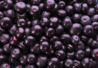 Fresh ripe acai berries as background, closeup