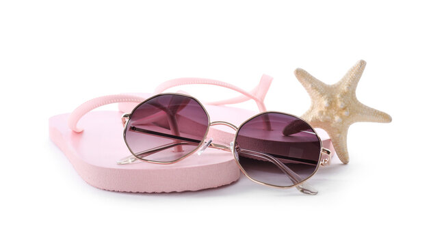 Flip flops, sunglasses and starfish on white background. Beach objects