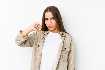 Young caucasian woman  isolated showing a dislike gesture, thumbs down. Disagreement concept.