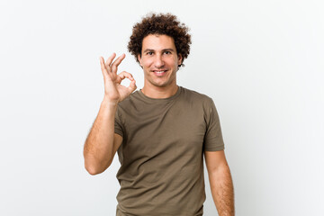 Mature handsome man isolated cheerful and confident showing ok gesture.