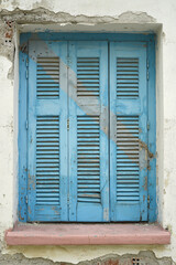 Wooden window of an old abandoned building on the island of Lesvos, Greece.