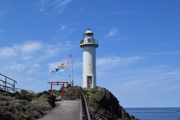 Fototapeta na wymiar 鼠ケ関灯台（恋する灯台）／ 山形県鶴岡市鼠ケ関の弁天島にある鼠ケ関灯台が、日本ロマンチスト協会などが企画した「恋する灯台」に選ばれました。恋する灯台に、全国20ヶ所21基を選定しました。