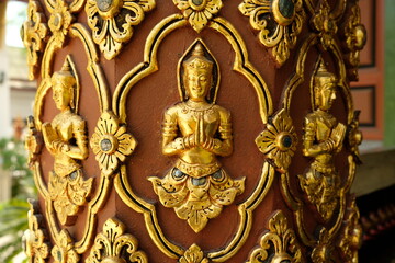 Fototapeta na wymiar Chiang Mai Thailand - Pillar with golden Buddha in Temple Wat Buppharam