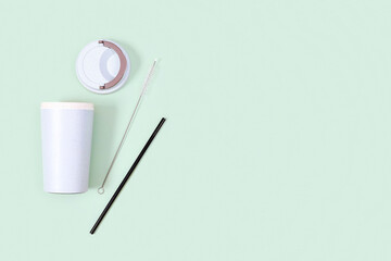 Reusable plastic free and eco friendly utensils. Metal drinking straws, bamboo coffee cup.