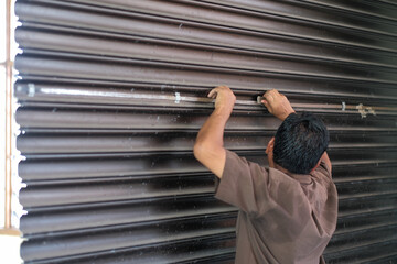 The  contractor is making reparation of rolling shutte