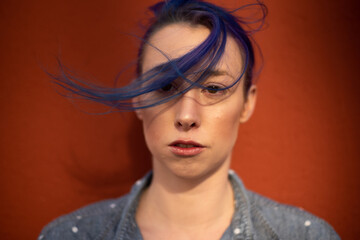 Fototapeta premium Tall young urban female enjoying the sunshine on a city rooftop overlooking Downtown Los Angeles.