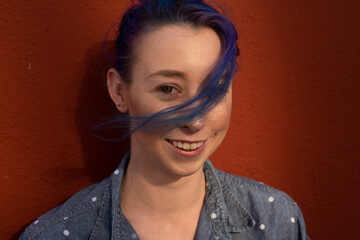 Tall young urban female enjoying the sunshine on a city rooftop overlooking Downtown Los Angeles.