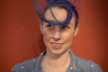 Tall young urban female enjoying the sunshine on a city rooftop overlooking Downtown Los Angeles.