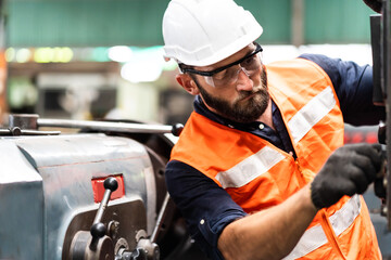 Man at work. Mechanical Engineer  man in Hard Hat Wearing Safety Jacket working in Heavy Industry...