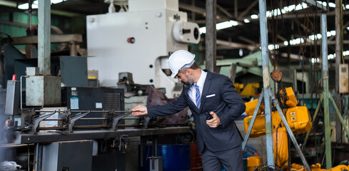 Man at work. Mechanical Engineer Bearded man in Hard Hat  in Heavy Industry Manufacturing Facility. Professional Engineer Operating lathe Machinery