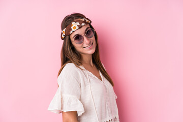 Young hipster caucasian woman isolated looks aside smiling, cheerful and pleasant.