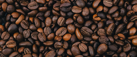 Coffee grains. Background of roasted coffee beans brown. layout.