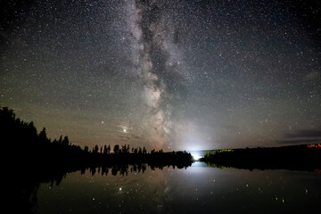 Milky Way and Stars Glowing during a Night Sky. Taken in Northern British Columbia, Canada. Lake Reflection
