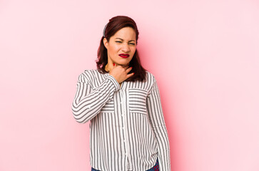 Fototapeta premium Middle age latin woman isolated on a pink background suffers pain in throat due a virus or infection.