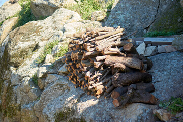 Fototapeta na wymiar firewood pile up over a rock wall