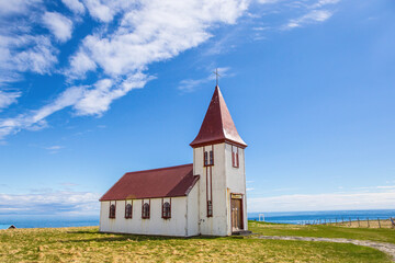 Fototapeta na wymiar A red church, the landmark in Hellnar, Snaefellsnes, in Iceland, on a sunny day.