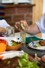 Close up of the hand of an anonymous man preparing a shot of tequila