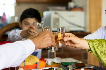 Close up of the hands of a family toasting