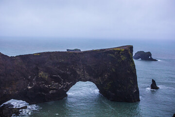 Fototapeta premium Dyrholaey, the south corner at the coast of Iceland, on a cloudy day, summer time.