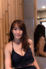 Fototapeta na wymiar Closeup Asian woman in a sexy black bikini Stay in the hotel bathroom
