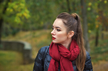 Close-up portrait of a young beautiful woman in an Autumn city Park