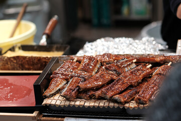 fresh water eel or unagi Japanese eel grilled with soft fire sold at Kuromon Market , Osaka Japan