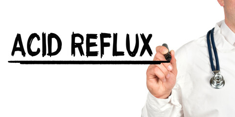 Doctor writes the word - ACID REFLUX. Image of a hand holding a marker isolated on a white background.