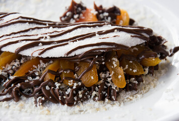 Apricot fruit tapioca with chocolate on a white dish and dark background