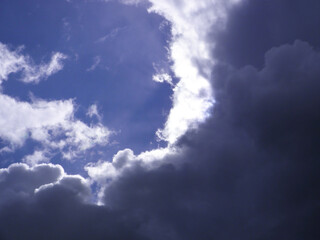 Blue sky among dark clouds.