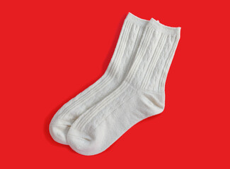 pair of grey socks for lady on red background