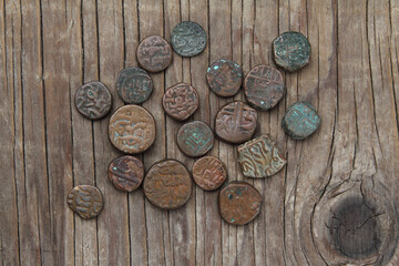 old coins on a wooden background.