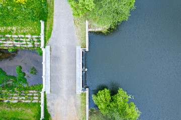 dam barrier on small pond in countryside. aerial top view from flying drone