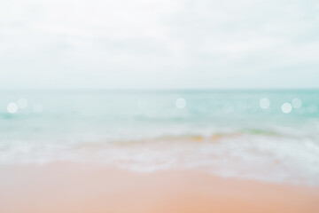 Blur tropical nature clean beach and white sand in summer with sun light blue sky and bokeh