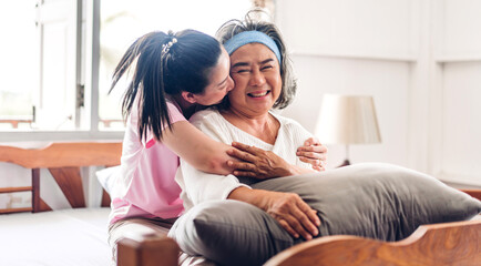 Obraz premium Portrait of enjoy happy love asian family senior mature mother and young daughter smiling laughing embracing and having fun together in moments good time at home