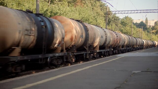 Electric Locomotive With Wagons Rides On Steel Railway.Heavy Industry Transportation Concept.Cargo Train Moving On Platform Staion.Kiev City Logictics.Freight Train Passing Through Passenger Station.