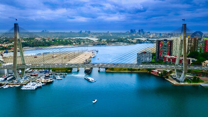 Obraz premium Panoramic drone aerial view over Sydney harbour on a cloudy sunset showing the nice colours of the CBD aparments and officer towers