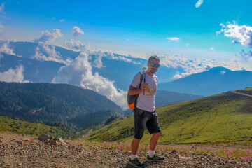 Naklejka premium young man walking in the mountains