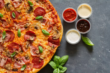 Pizza with extra sauces and empty space still life