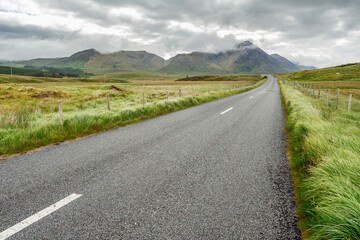 Small asphalt road in Connemara, county Galway, Ireland, Nobody, Dramatic cloudy sky.