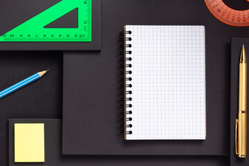 school accessories and office supplies at black background surface