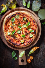 Homemade pizza made of wild mushrooms and zucchini flower