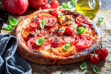 Delicious pizza Margherita served with sesame and olive oil