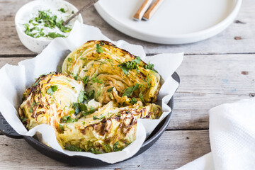 Baked cabbage slices. Vegan diet. Healthy grilled cabbage steaks with souse, spices and herbs.