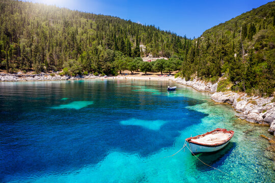 The small and beautiful Foki beach at the island of Kefalonia, Ionian Sea, Greece, with green hills and turquoise sea during summer time