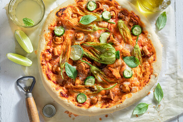 Tasty pizza served with cold and homemade lemonade