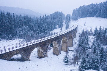 old snowy viaduct. old snow-covered railway bridge in Ukraine